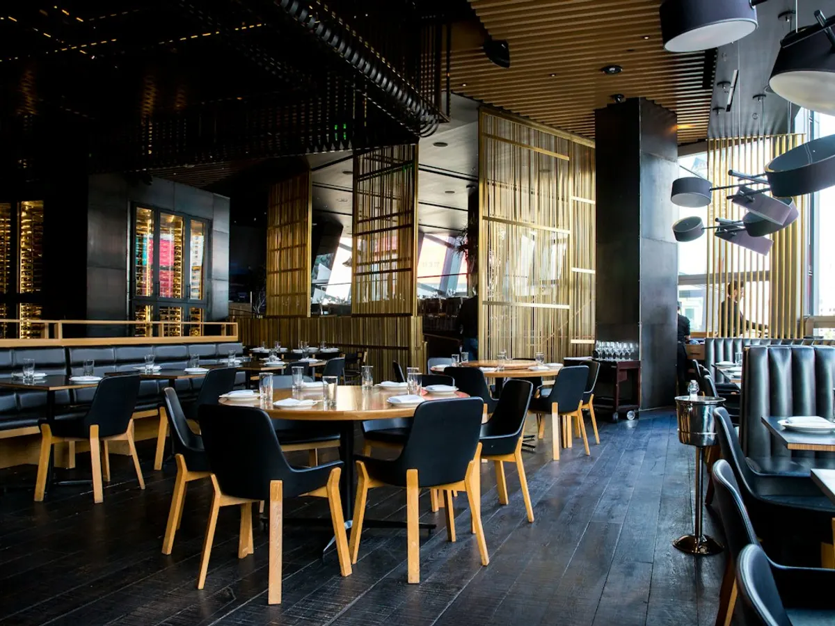 Contemporary restaurant dining room with warm wood and natural light